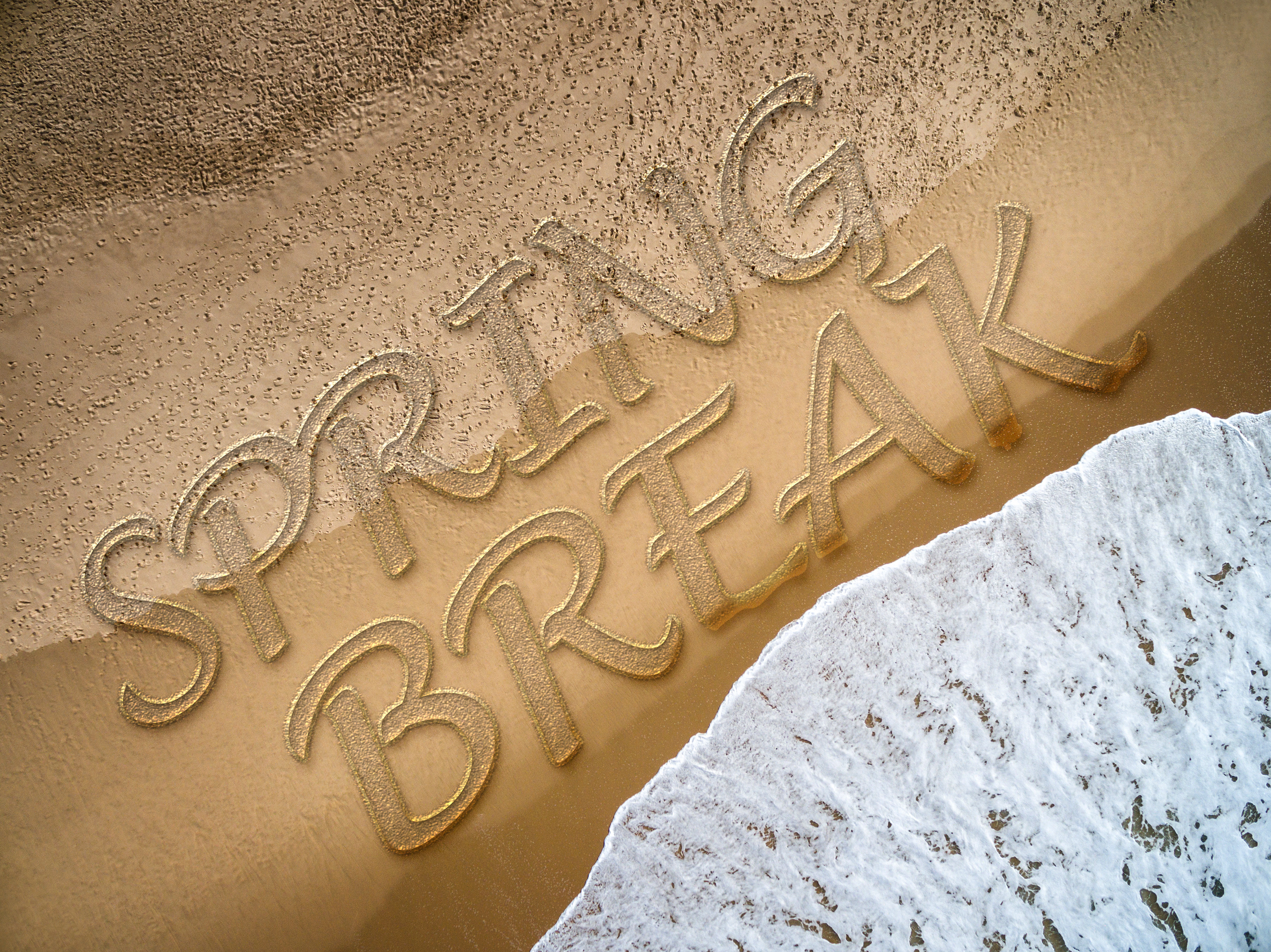 SPring break written on the beach
