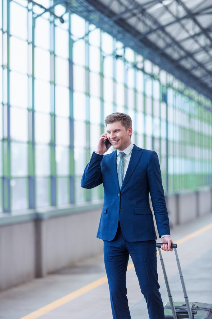 travel business man with suitcase and phone