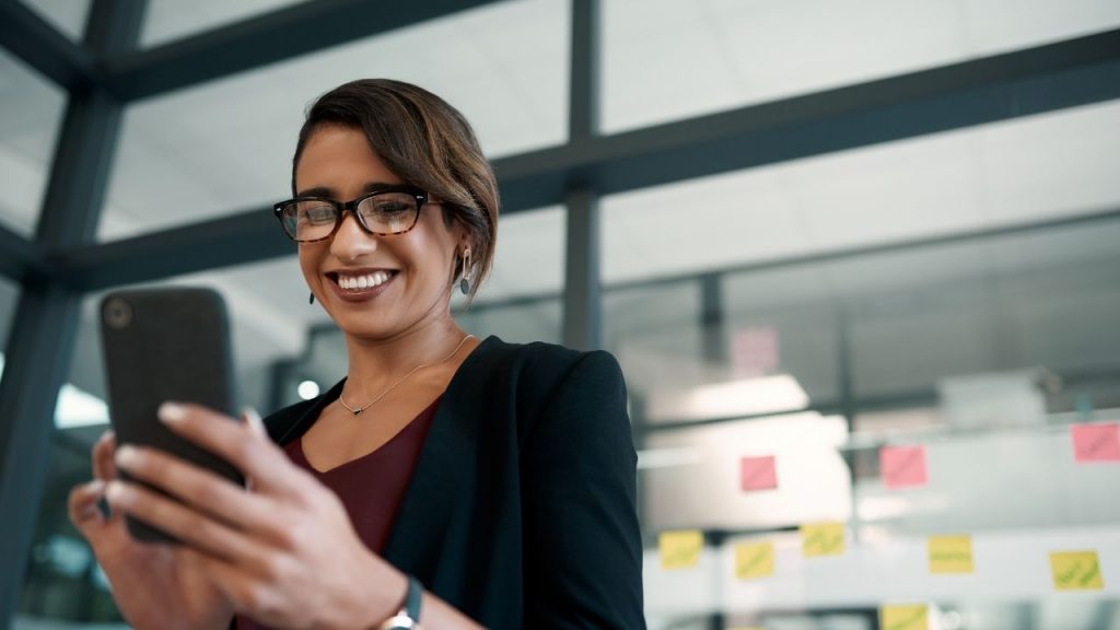 employee looking at social media on mobile phone