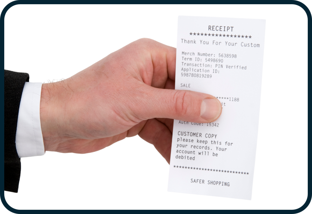 A thumb covering the transaction amount on a receipt